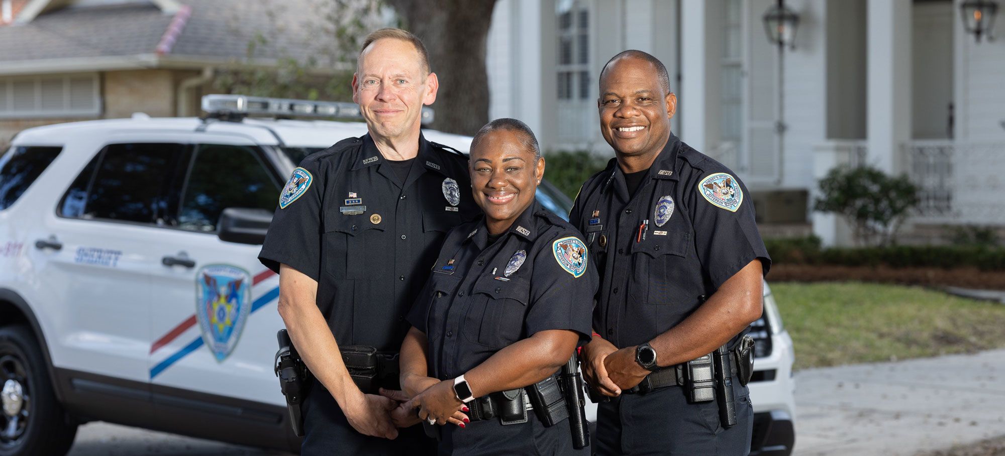 three officers smiling and looking at camera